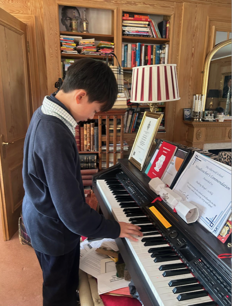 A student enjoying piano during time away from school